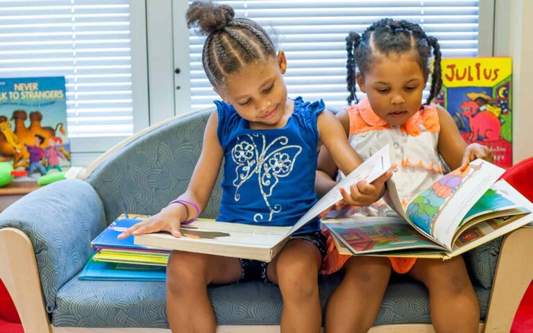 HERO-girls-reading-on-couch