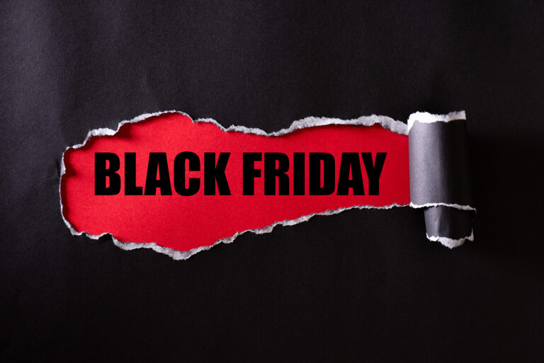 Top view of Black torn paper and the text black friday on a red