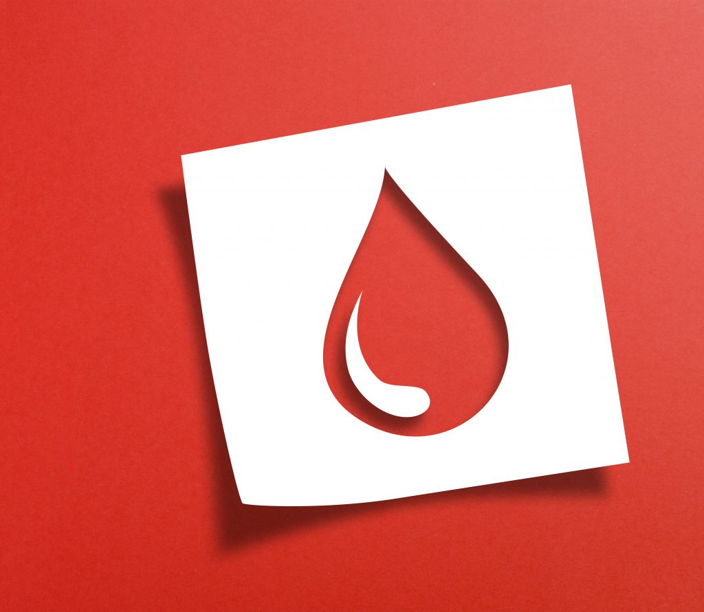 Note paper with blood donation concept on red background