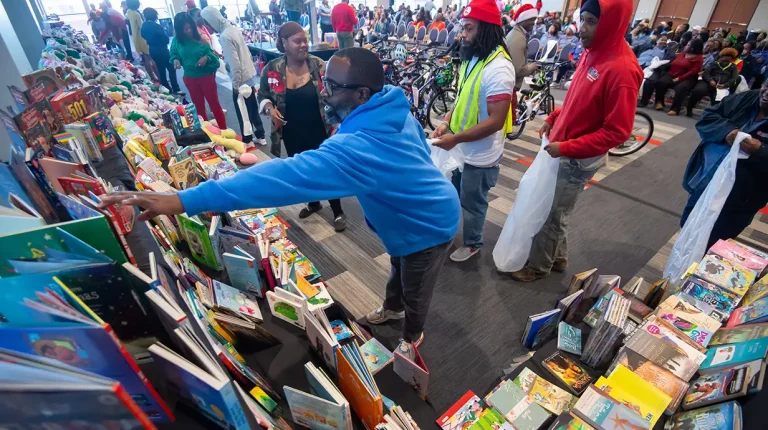 Staff members from the Facilities Management Department choose books and toys for their families during the 2023 Books and Bears event. Donations are being accepted for this year's Books and Bears, which distributes hundreds of new children's books and toys donated by Ole Miss faculty, staff, students and alumni. Photo by Kevin Bain/Ole Miss Digital Imaging Services