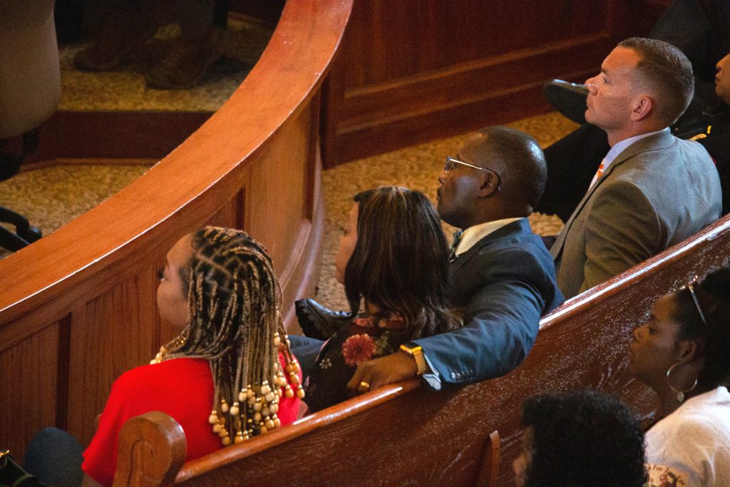 The family of Jimmie “Jay” Lee looked on in court as the bond hearing and preliminary trial of the man accused of killing him unfolded in the Lafayette County Courthouse on Tuesday, Aug. 9, 2022. Lee’s parents, Jimmie and Stephanie Lee, and sister, left, sat beside Oxford Police Department Police Chief Jeff McCutchen, right, in the front row of the courtroom.  Photo by Grace Marion