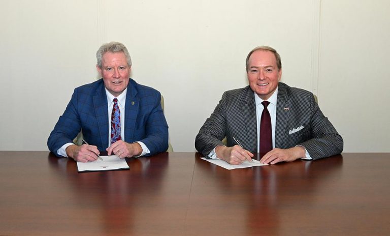 University of Mississippi Chancellor Glenn Boyce, left, and Mississippi State University President Mark E. Keenum celebrate a new agreement allowing qualified MSU students to enter UM’s Juris Doctor program before fully completing an MSU bachelor’s degree, accelerating the total length of undergraduate studies plus law school by one full year. A similar agreement is in place between MSU and Mississippi College's School of Law. (Photo by Beth Wynn)